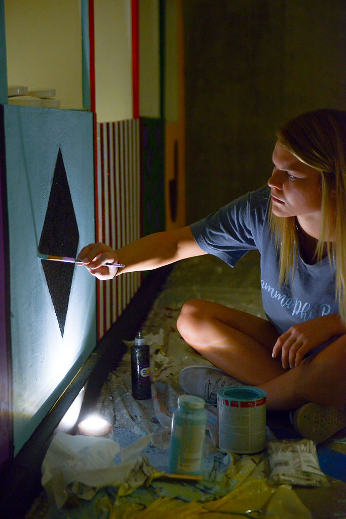 Natalie Miller decorates a game booth